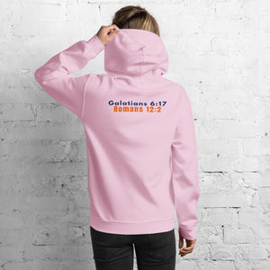 Back of Model wearing Gildan 18500 heavy blend hooded sweatshirt in Light Pink, showing a classic fit and Printed on the back is the Marked & Chosen Verses: Galatians 6:17 and Romans 12:2.