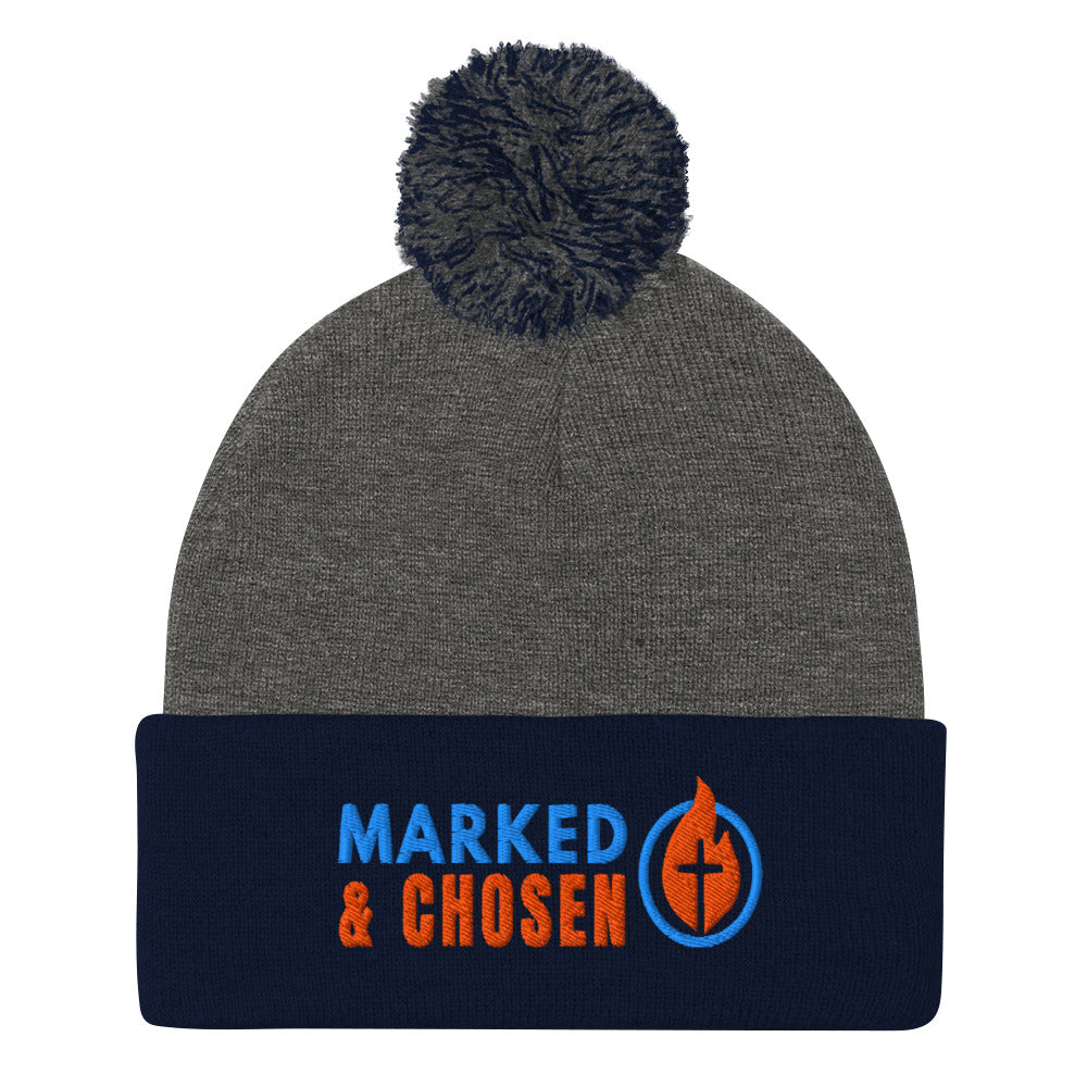 Dark Heather Grey and Navy Sportsman SP15 pom pom cuffed knit cap with Marked & Chosen Logo Embroidered on a white background.
