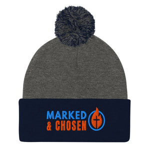 Dark Heather Grey and Navy Sportsman SP15 pom pom cuffed knit cap with Marked & Chosen Logo Embroidered on a white background.