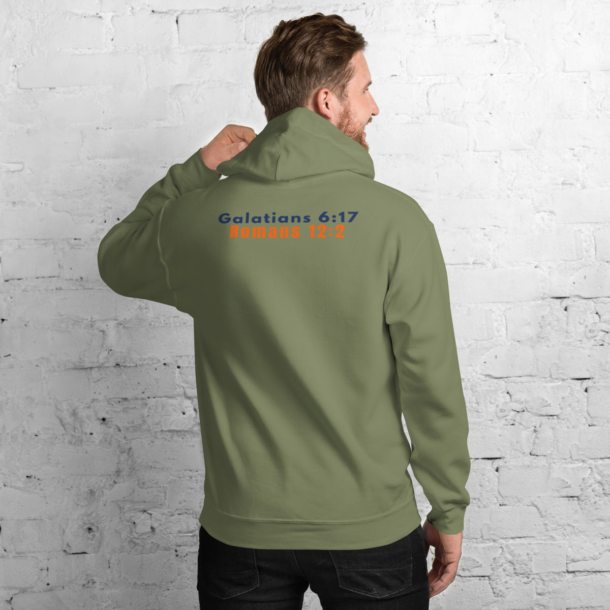 Back of Model wearing Gildan 18500 heavy blend hooded sweatshirt in Military Green, showing a classic fit and Printed on the back is the Marked & Chosen Verses: Galatians 6:17 and Romans 12:2.